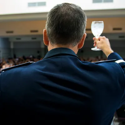 An officer raising a glass in a toast